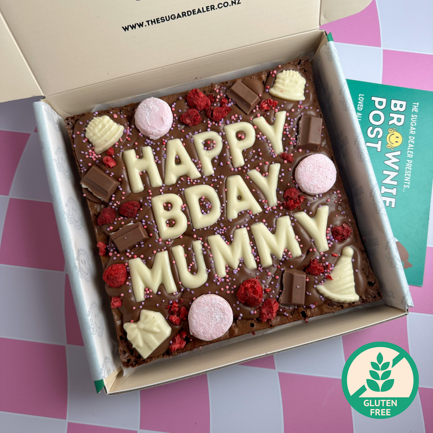 Fudgy gluten free brownie. This one's birthday themed, add a custom message and pick your toppings!