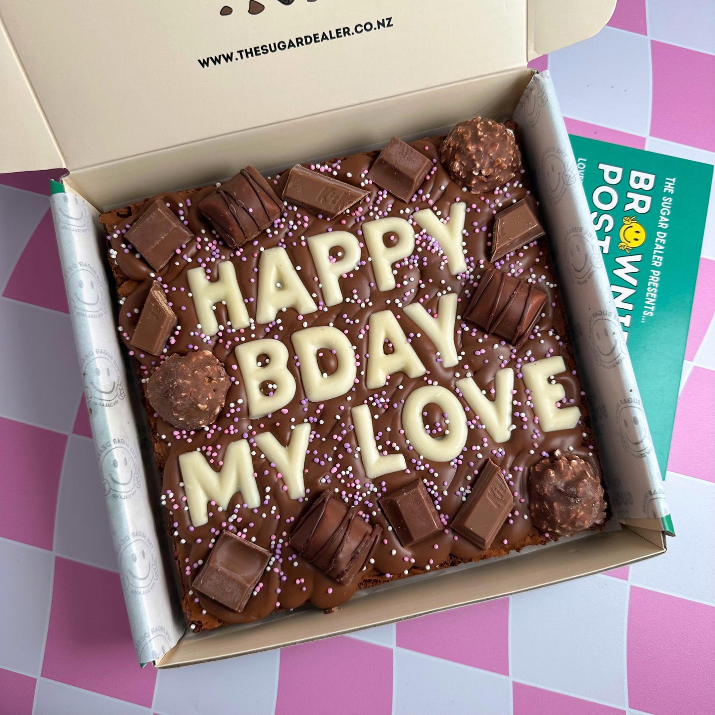 fudgy chocolate brownie decorated with your very own custom message and all the best chocolates, including ferrero rocher, kinder bueno, whittakers hazella and kitkat!